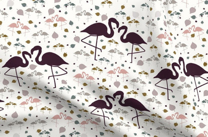 Floral fabric with a pattern of pink and purple flamingos on a white background